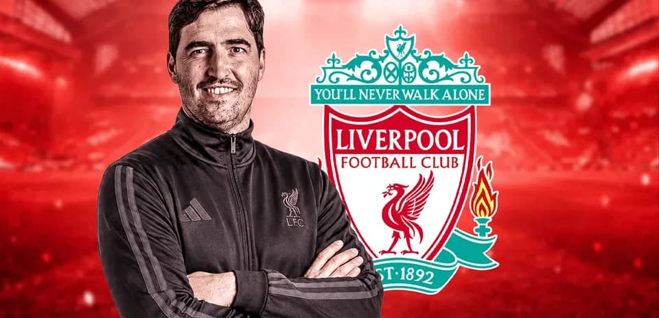 Coach posing with Liverpool FC logo background