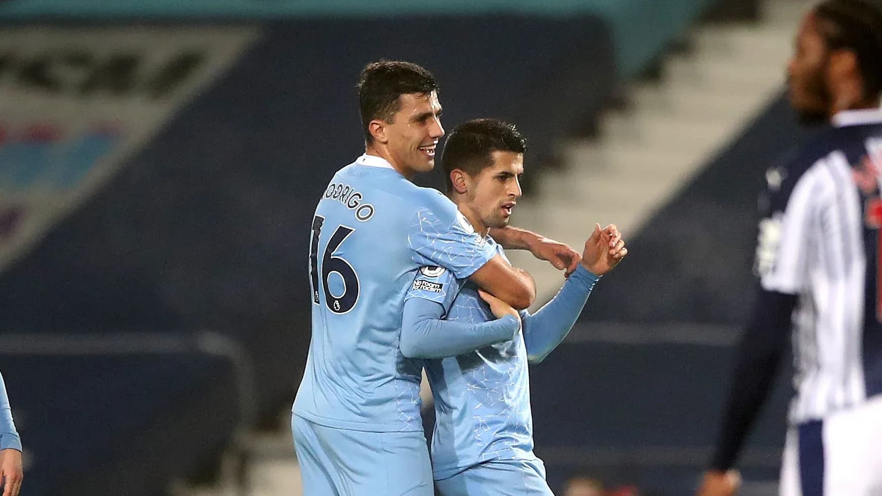 Two players celebrating a goal during a match