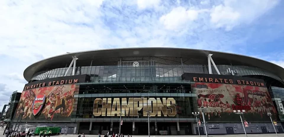 Emirates Stadium exterior with 'CHAMPIONS' sign