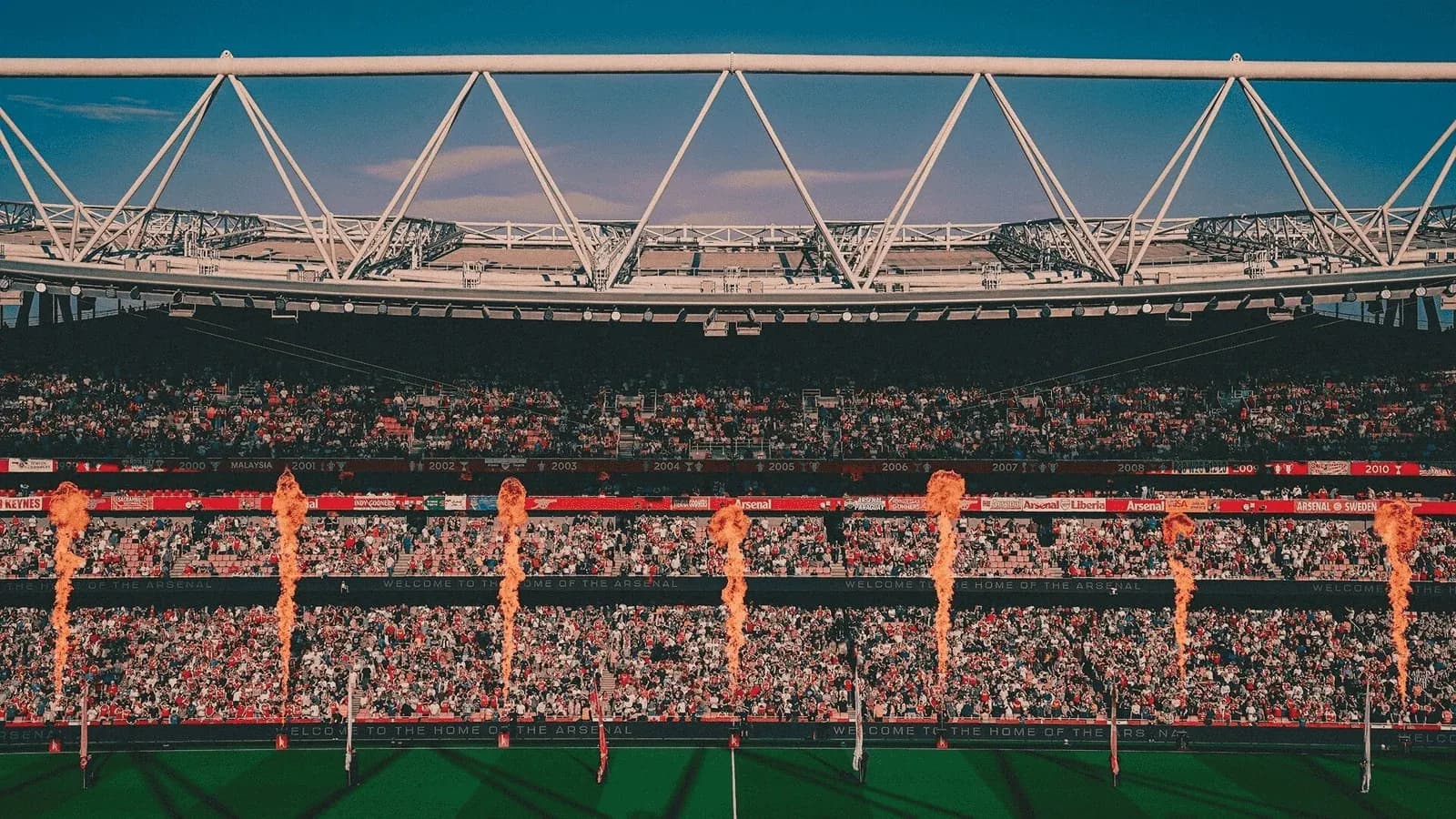 Stadium filled with fans and flame jets during event