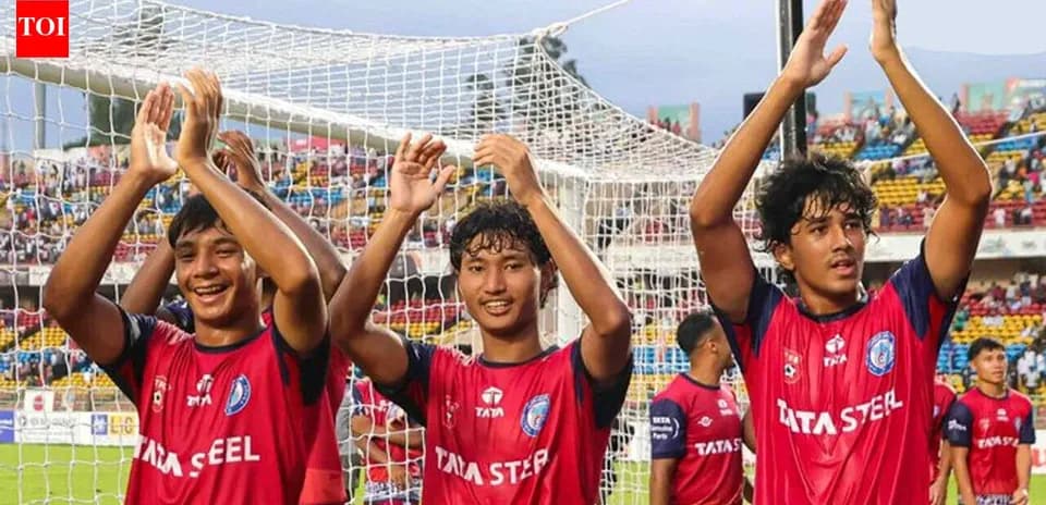 Three players celebrating with fans after match