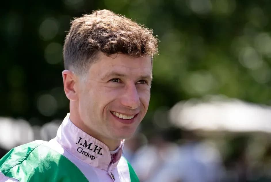 Jockey smiling in racing attire outdoors