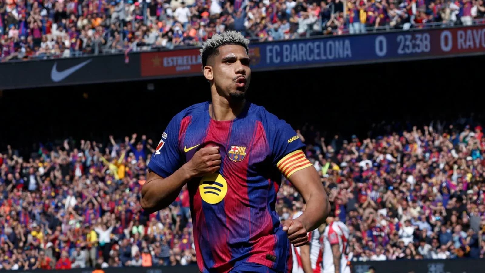 Barcelona player celebrating goal in front of crowd
