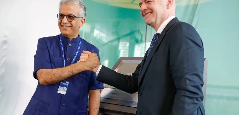 Two officials shaking hands at AFC event