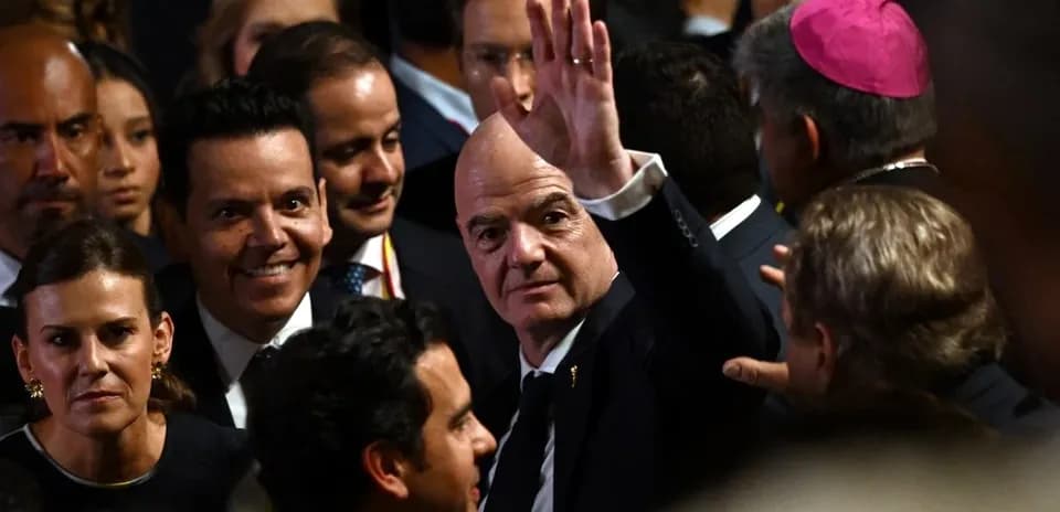 People gathered, one man waving in crowd