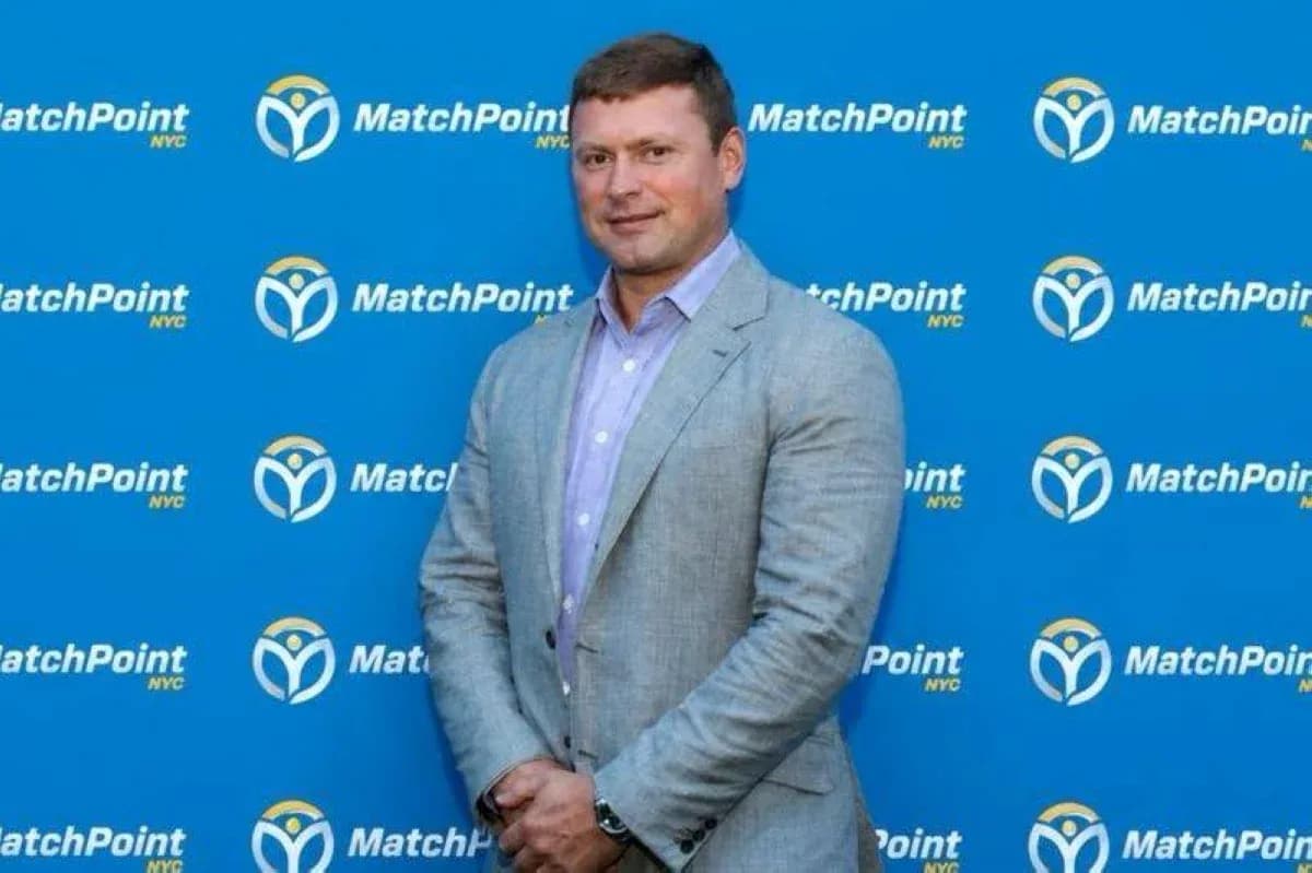 Man in suit posing in front of MatchPoint backdrop