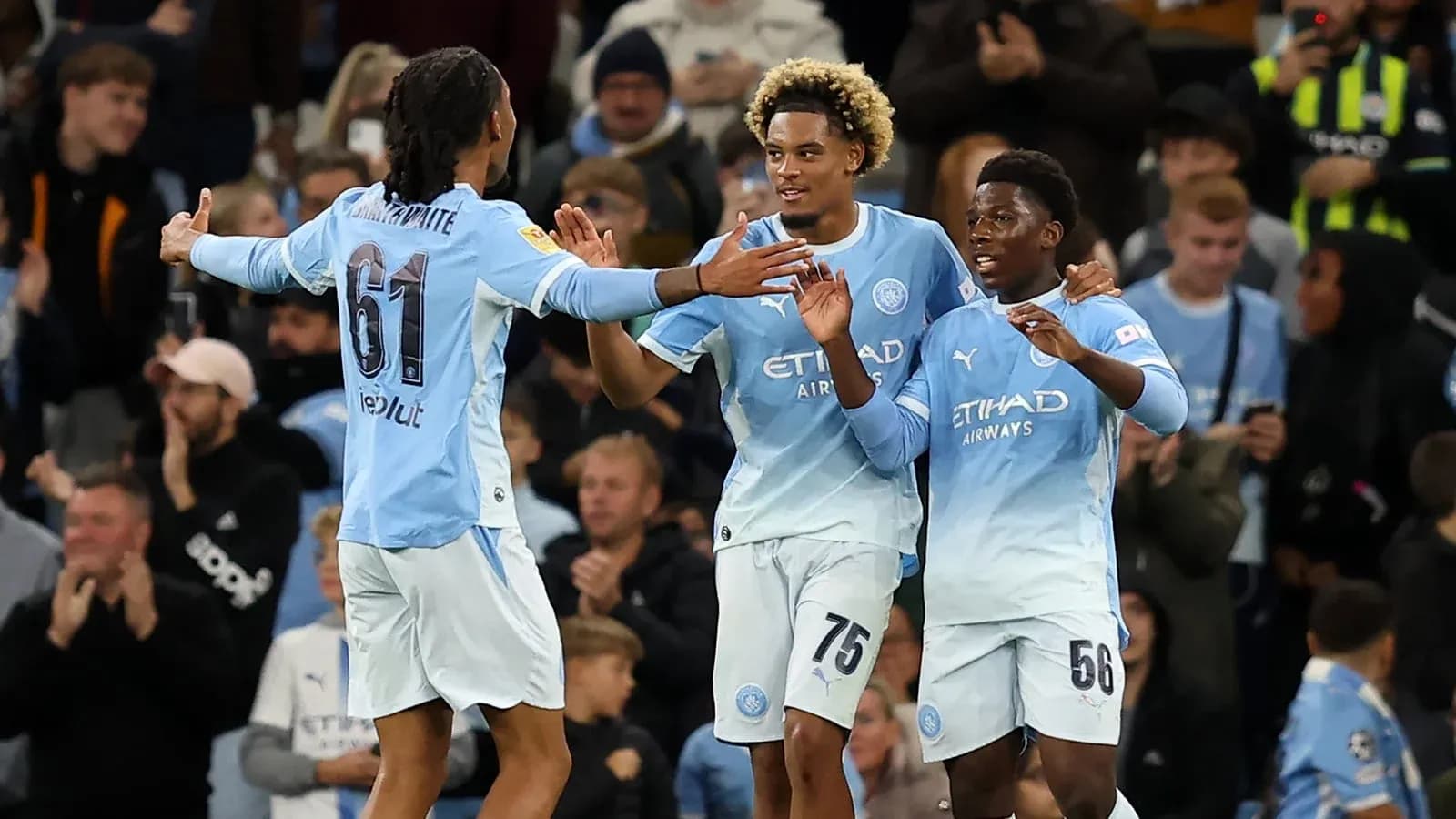 Manchester City players celebrating a goal together
