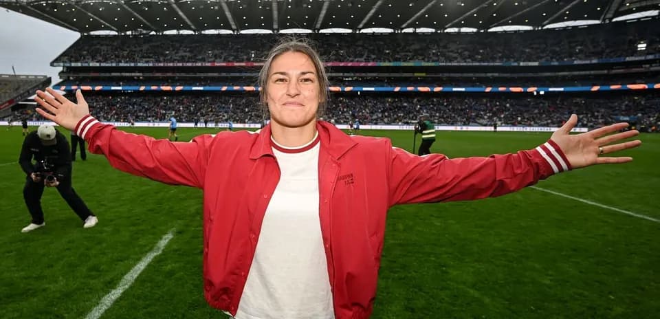 Player celebrating on the field with arms outstretched