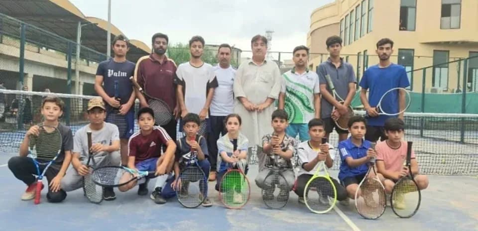 Tennis players posing on court after training session