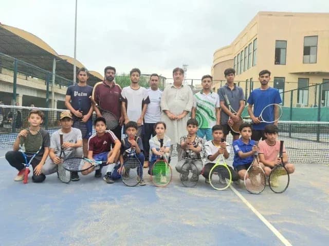 Tennis players posing on court after training session