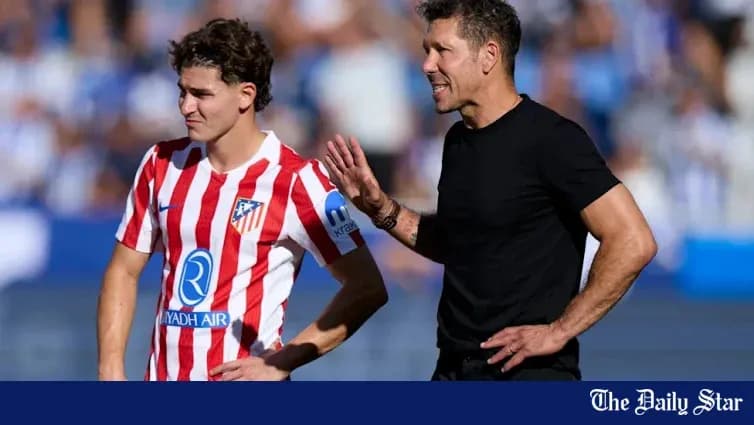 Atletico Madrid coach speaking to player during match