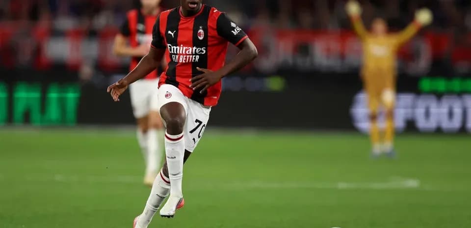 AC Milan player running with ball during match