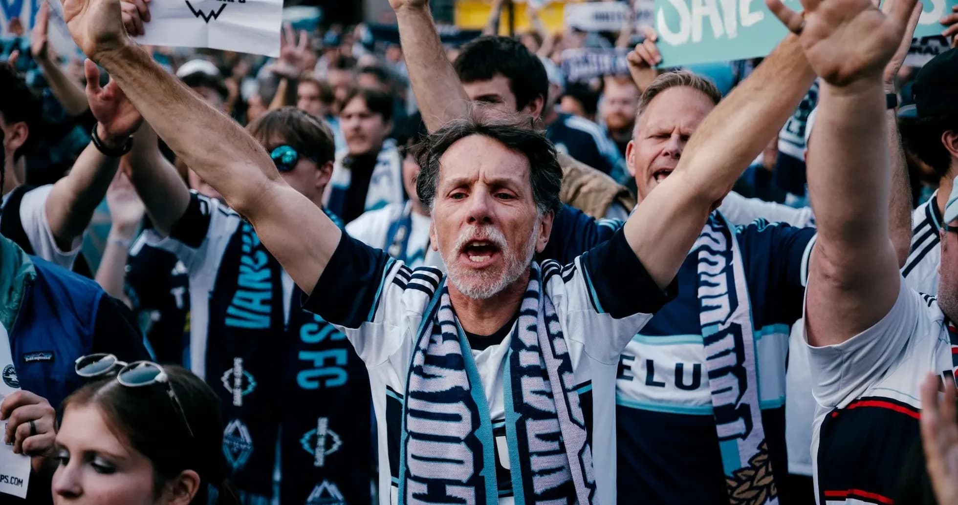 Vancouver Whitecaps fans cheering with banners