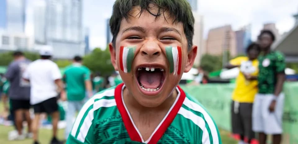 Boys cheering with face paint at soccer event