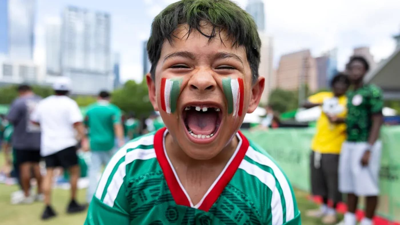 Boys cheering with face paint at soccer event