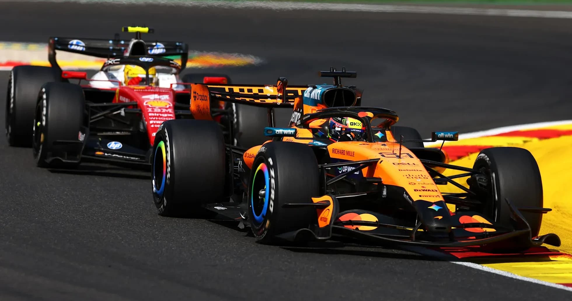 McLaren and Ferrari racing on track during competition