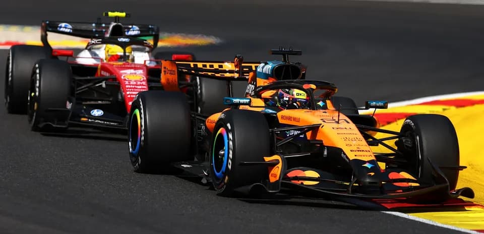 McLaren and Ferrari racing on track during competition