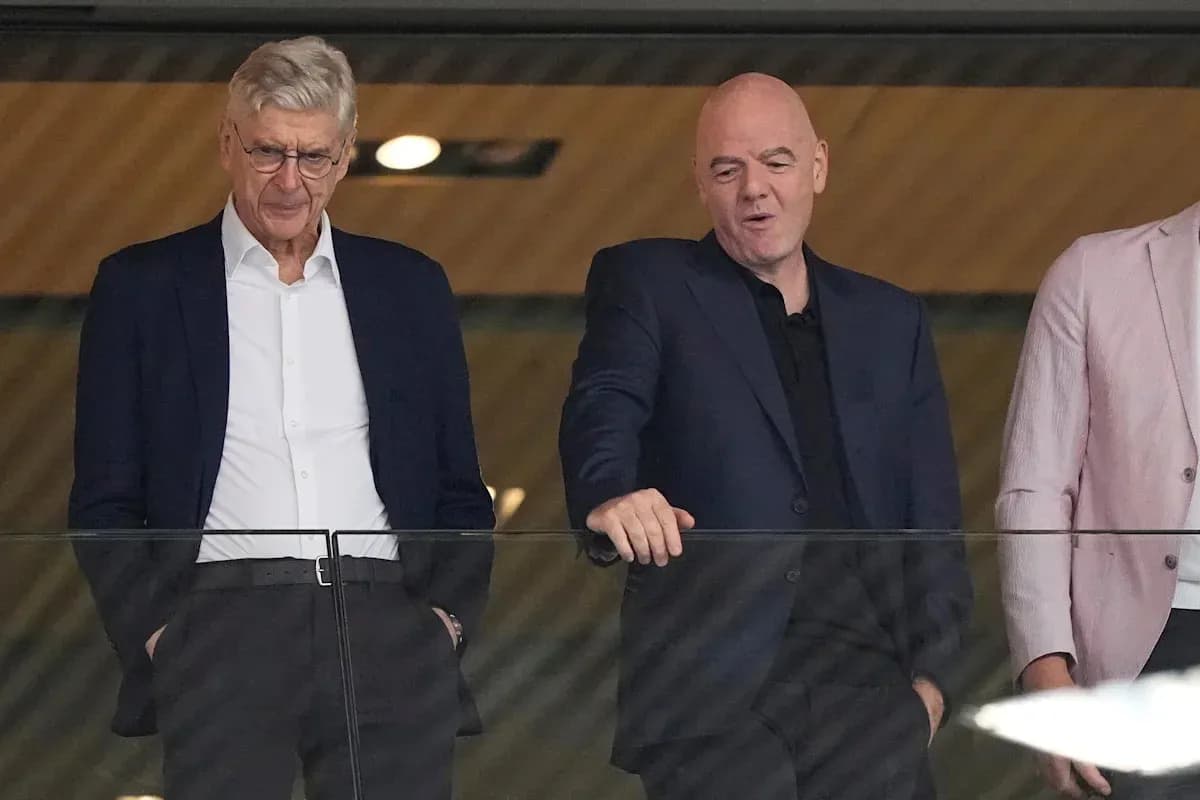 Two men conversing in a stadium box