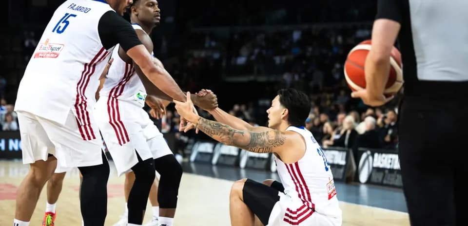 Two players helping teammate get up during game