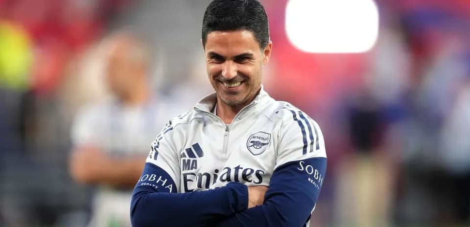 Arsenal manager smiling during training session