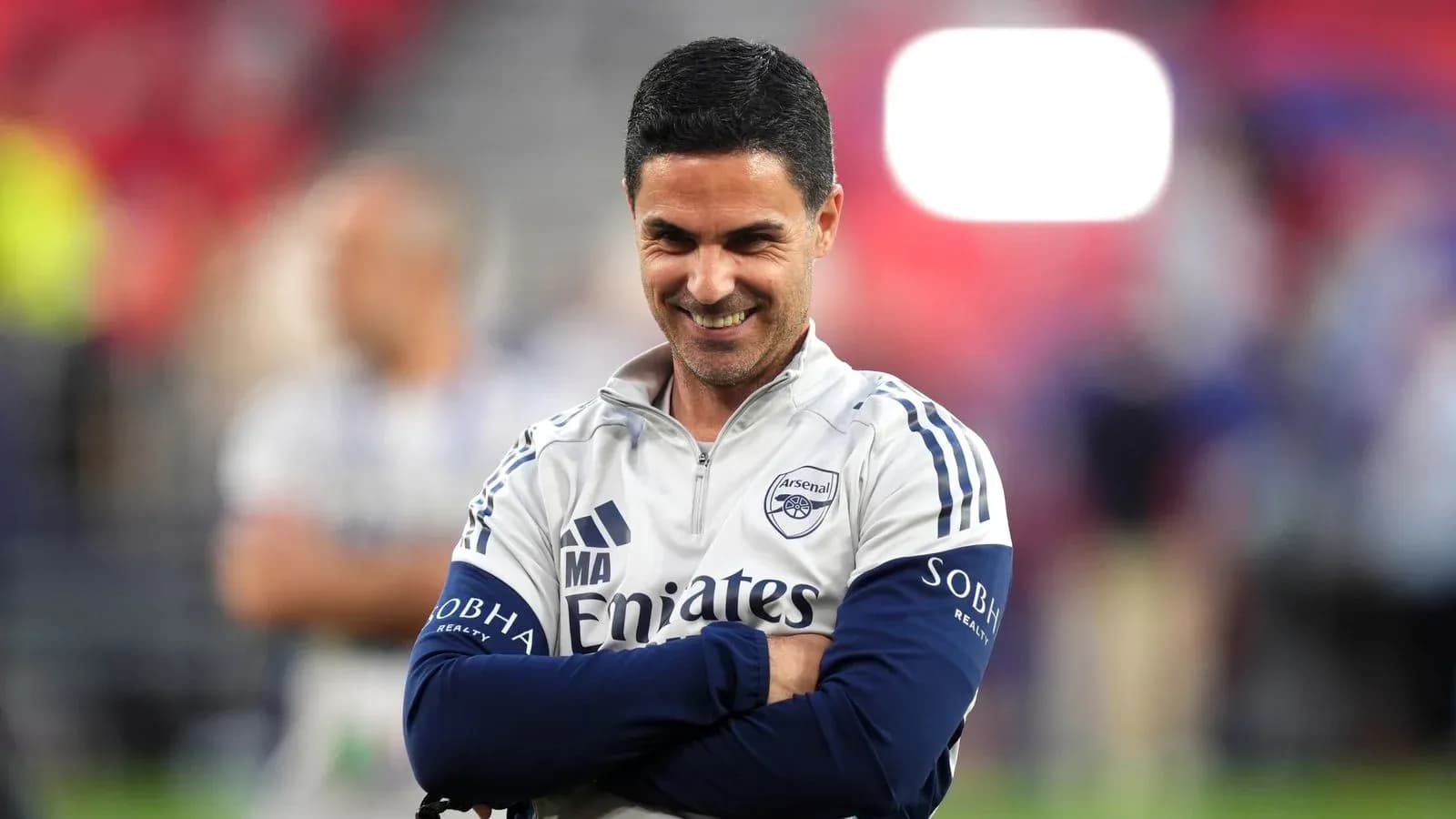 Arsenal manager smiling during training session