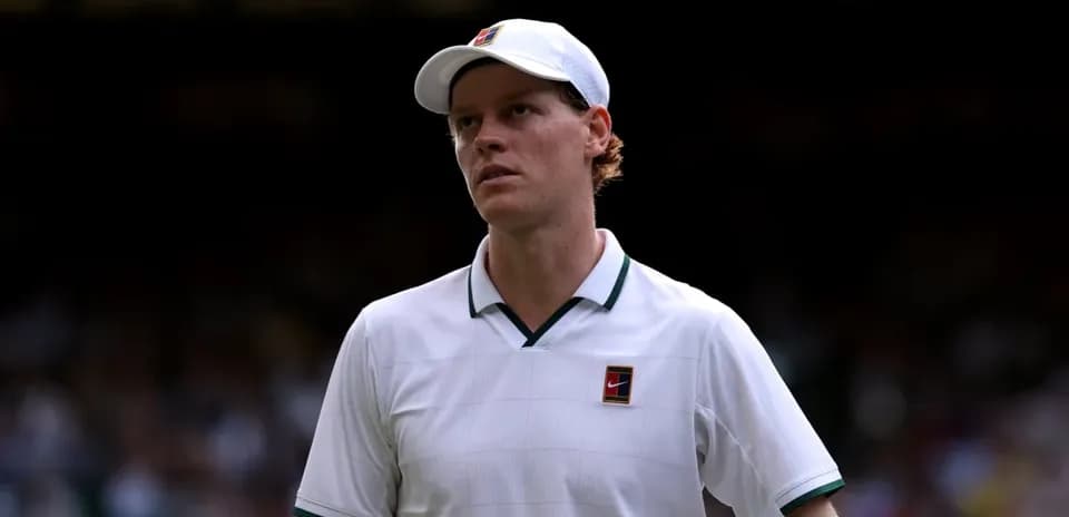 Tennis player in white shirt walking on court