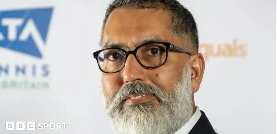 Man with glasses and beard posing for photo