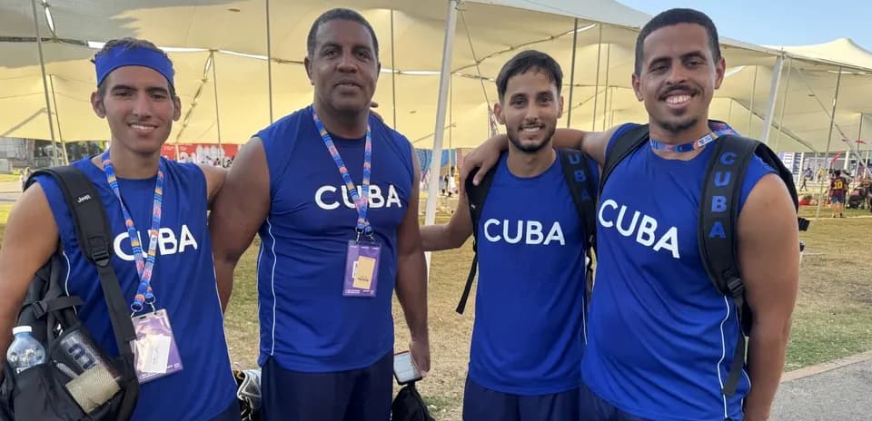 Cuban athletes posing together in blue jerseys