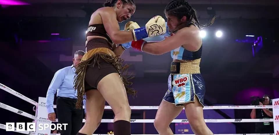 Two female boxers engaging in a match