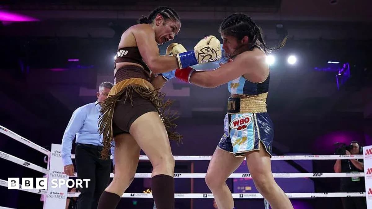 Two female boxers engaging in a match