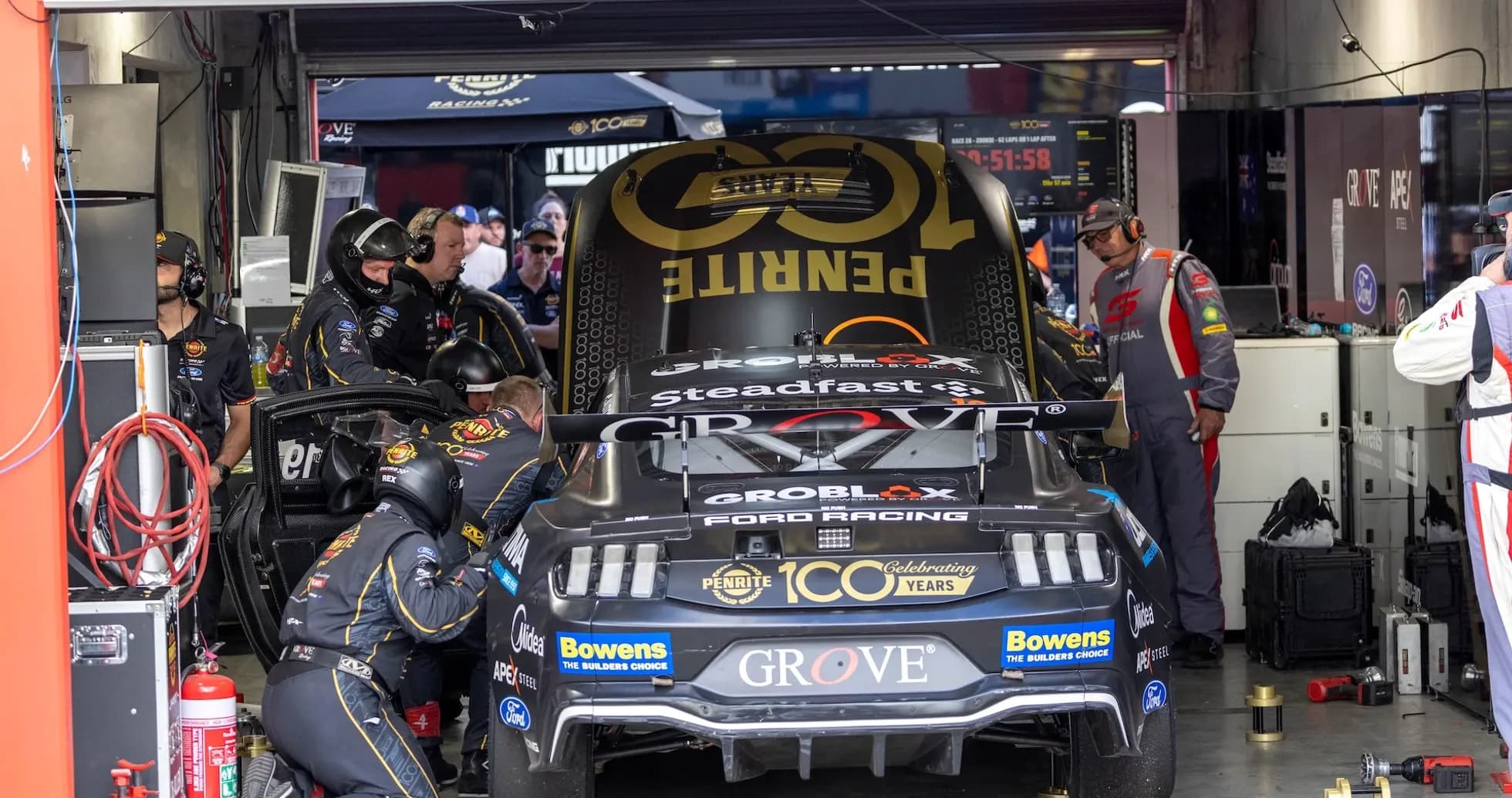 Mechanics working on a race car in the garage