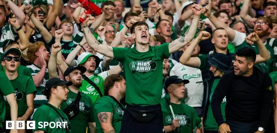 Fans cheering with a megaphone during match