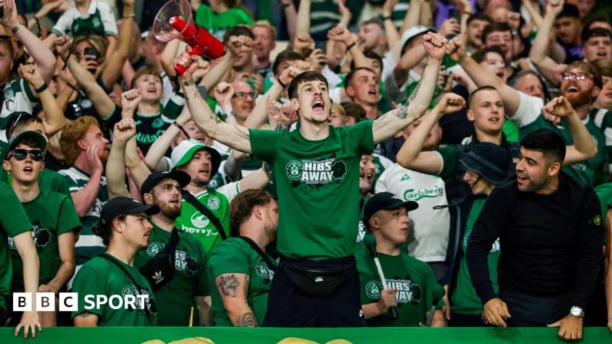 Fans cheering with a megaphone during match