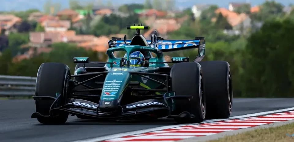 Formula 1 car racing on track with trees in background