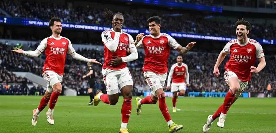 Arsenal players celebrating a goal on the field