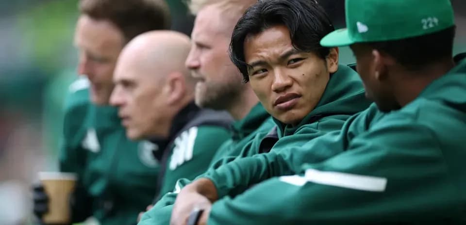 Players seated on bench during a match