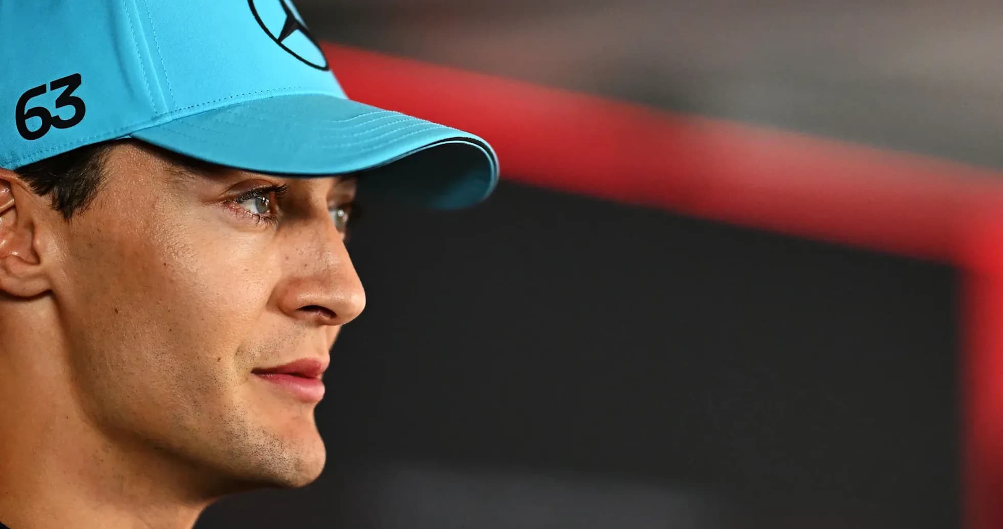 Formula 1 driver wearing blue cap with logo