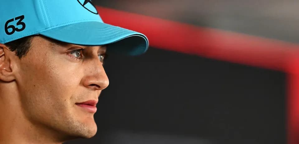 Formula 1 driver wearing blue cap with logo
