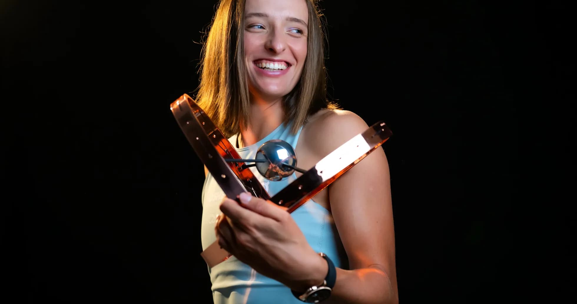 Athlete holding an award with a smile