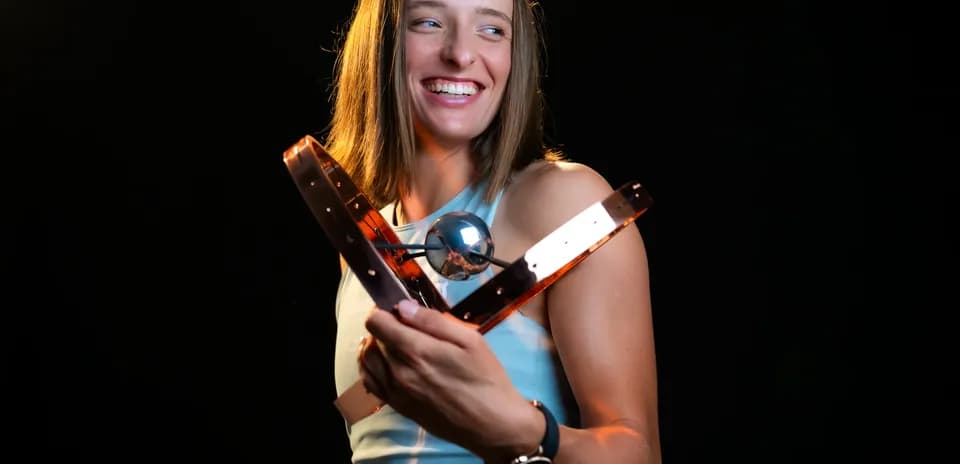Athlete holding an award with a smile