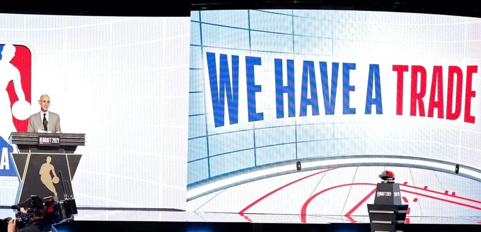 NBA commissioner announcing trade during draft event