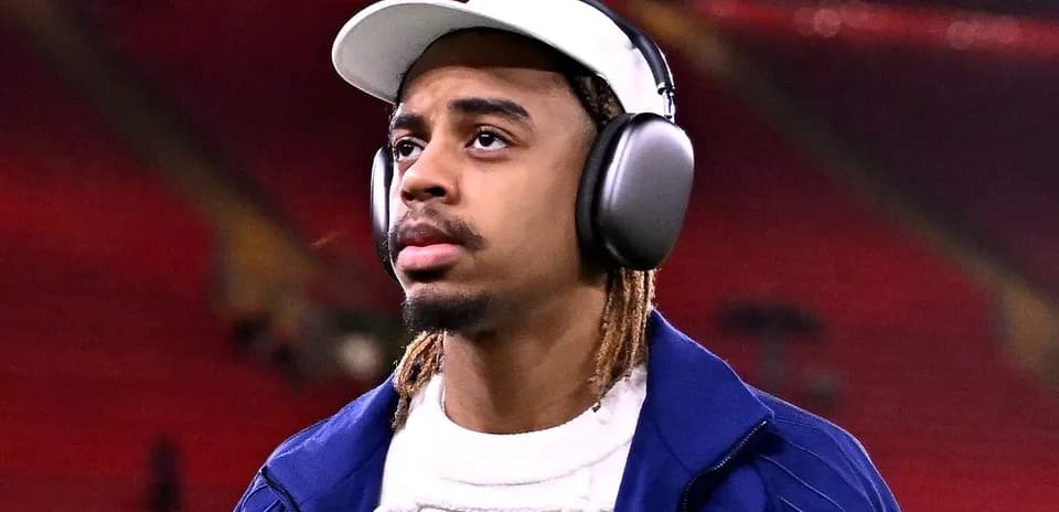 Football player wearing headphones in stadium