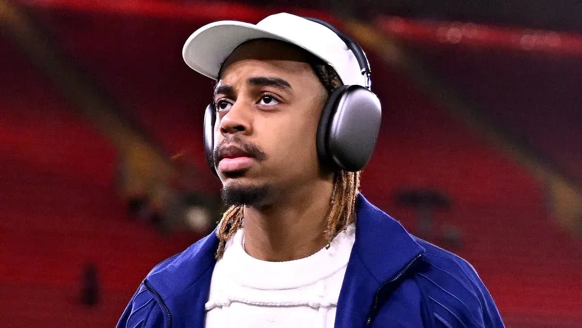 Football player wearing headphones in stadium