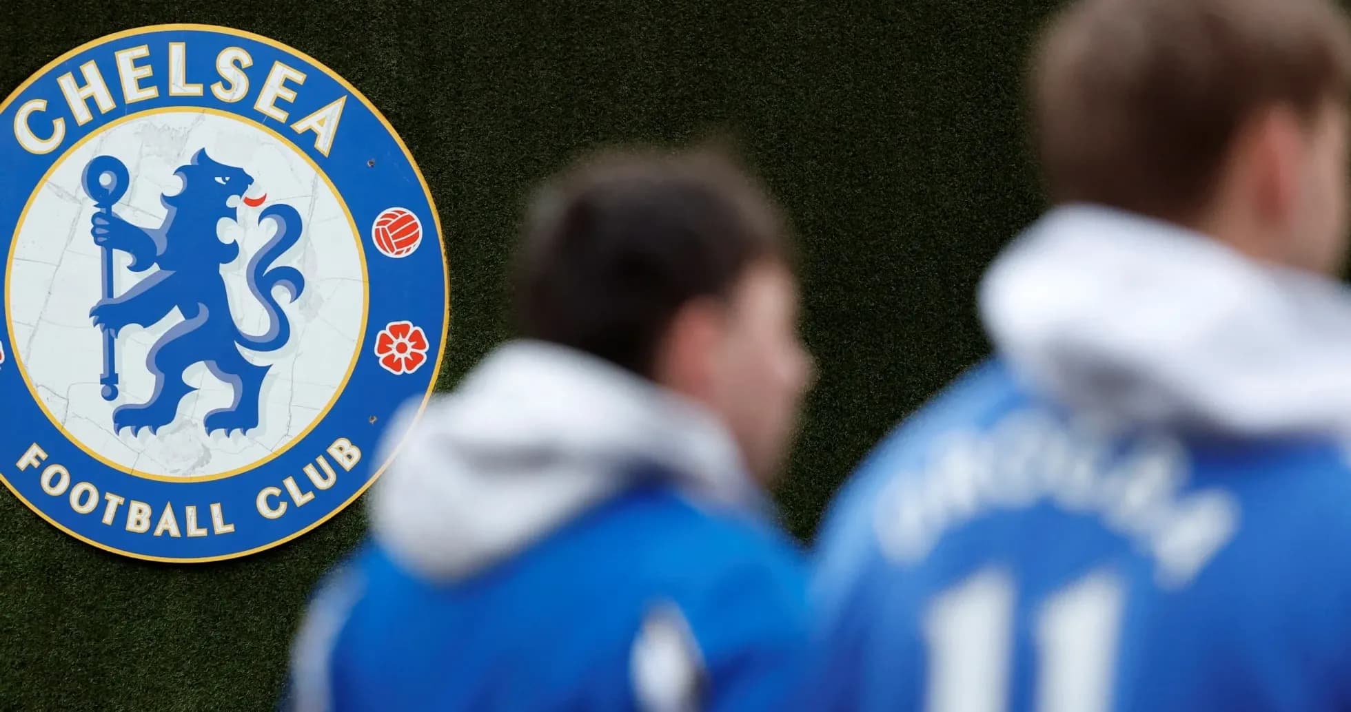 Chelsea FC logo with players in training gear