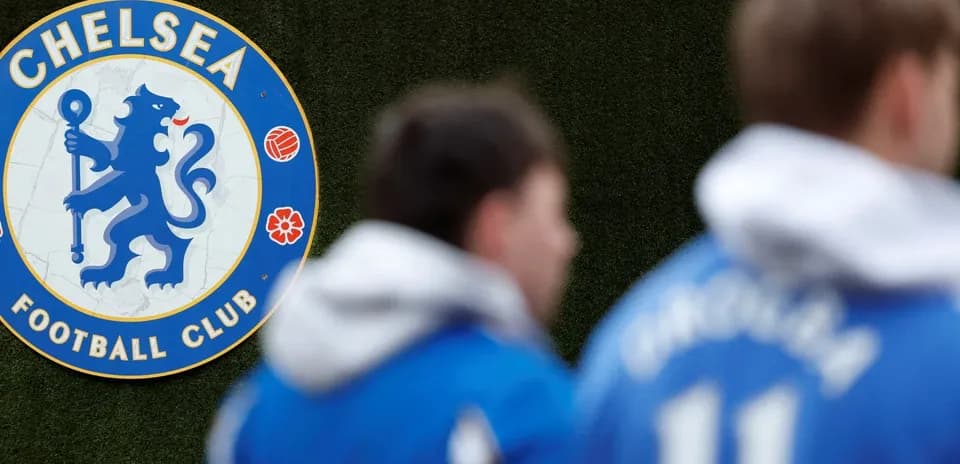 Chelsea FC logo with players in training gear
