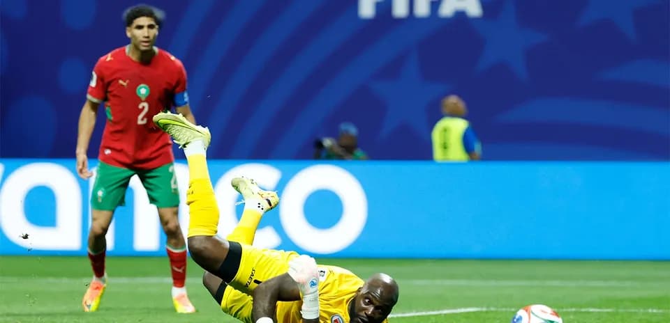 Goalkeeper diving for the ball during match action
