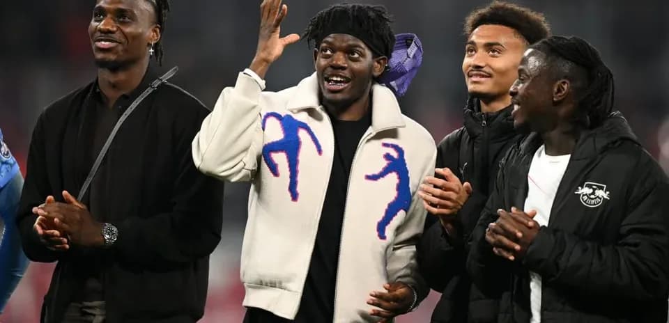 Four players celebrating together in stadium