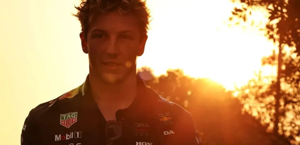 Yoshida sunsetting behind a racing driver in uniform