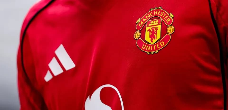 Manchester United logo on red jersey