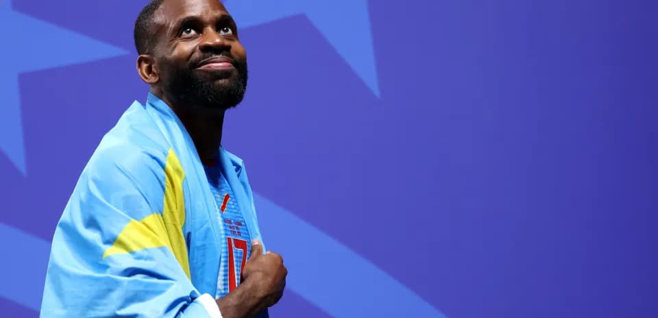 Athlete wearing flag, looking up during event